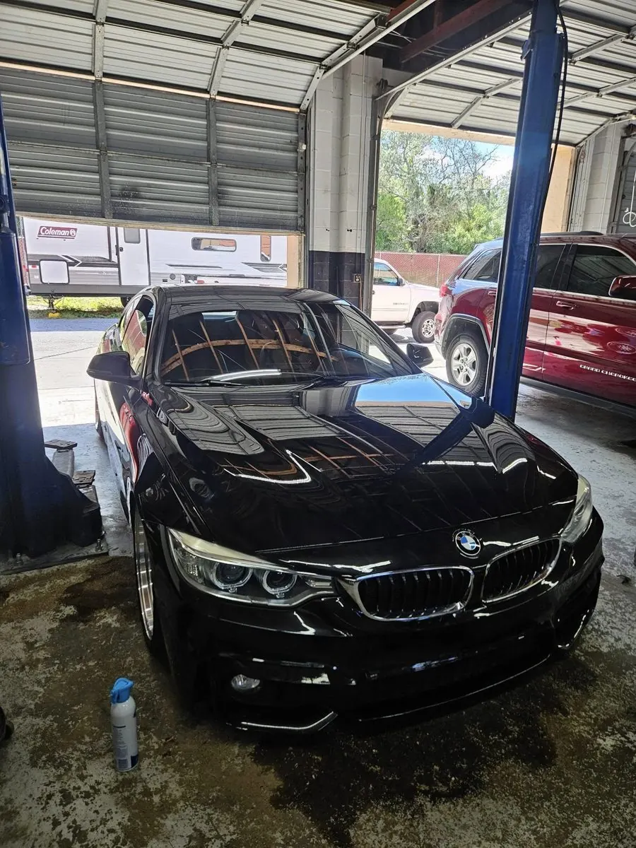 Black BMW coupe with chrome wheels