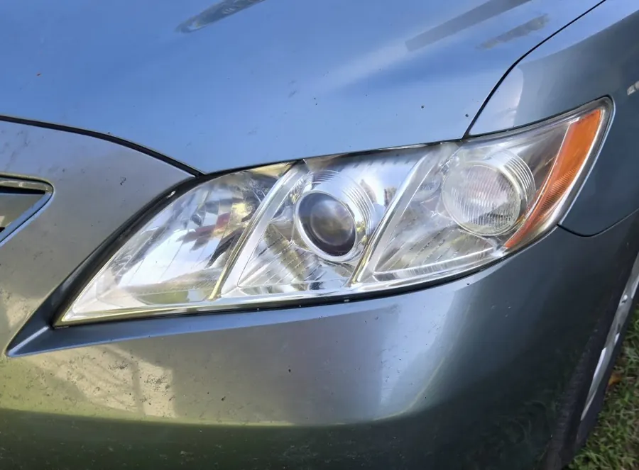 Clear headlight on a Toyota Camry after restoration